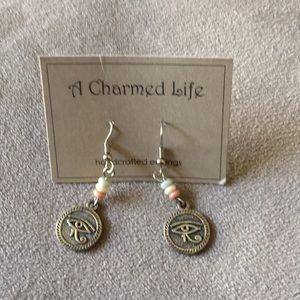 Never used! Eye of horas or sun god earrings.